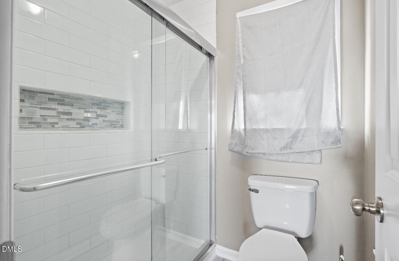 999 Flintwood Road Fayetteville, NC 28314 - Photo 19 of 23 a bathroom with a toilet and a shower