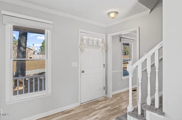 a view of entryway with wooden floor and stair
