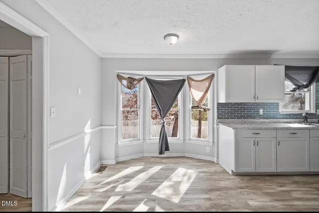 a view of a kitchen from a hallway