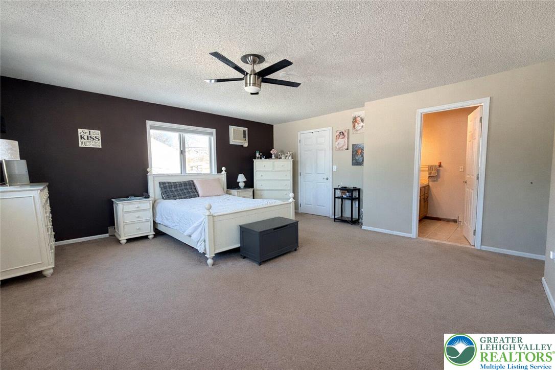 1060 Arbor Lane Slatington, PA 18080 - Photo 21 of 46 a bedroom with a bed and a chandelier