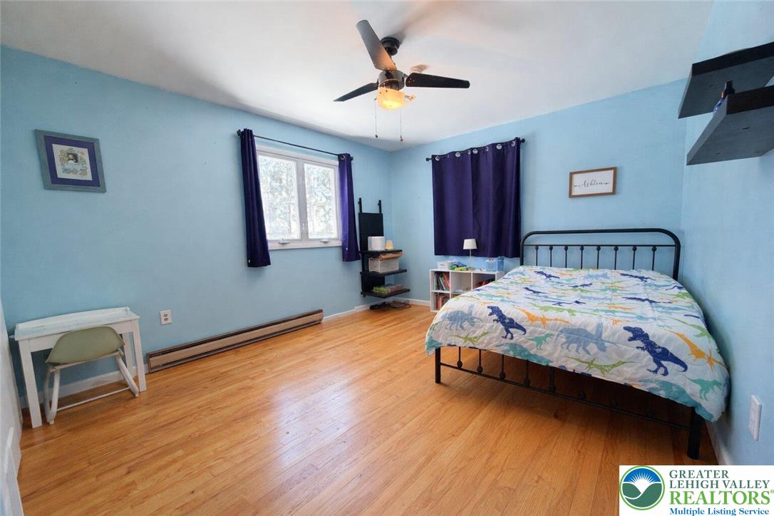 1060 Arbor Lane Slatington, PA 18080 - Photo 25 of 46 a bedroom with a bed and wooden floor