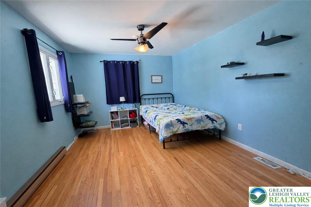 1060 Arbor Lane Slatington, PA 18080 - Photo 26 of 46 a bedroom with a bed and wooden floor