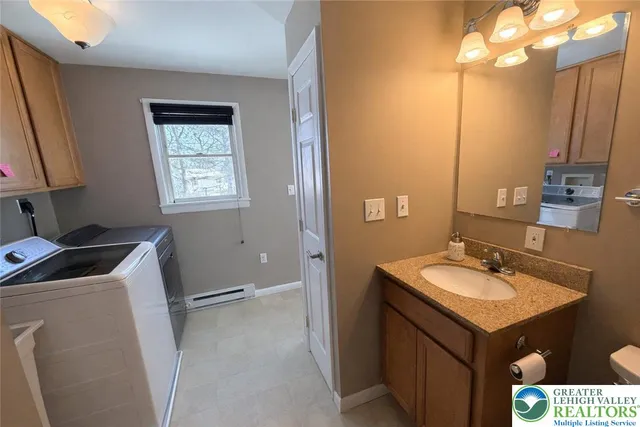 a bathroom with a sink vanity and a mirror