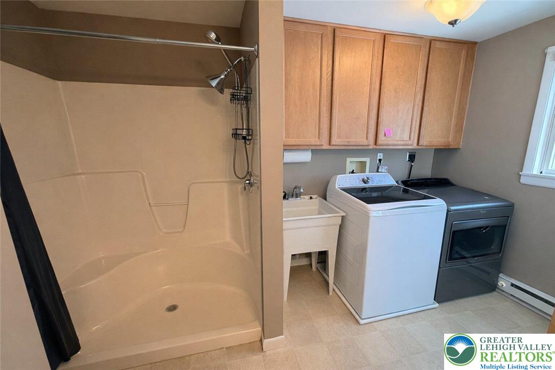 1060 Arbor Lane Slatington, PA 18080 - Photo 34 of 46 a bathroom with a granite countertop sink a mirror and a shower