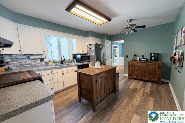 a kitchen with stainless steel appliances granite countertop a stove a sink dishwasher and a refrigerator
