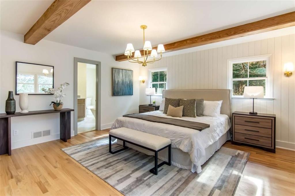 4956 Mountclaire Road Stone Mountain, GA 30087 - Photo 25 of 61 a spacious bedroom with a bed and wooden floor