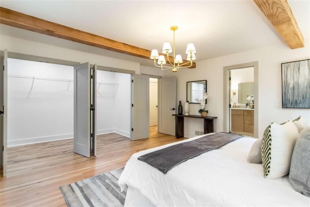 4956 Mountclaire Road Stone Mountain, GA 30087 - Photo 28 of 61 a spacious bedroom with a bed and wooden floor
