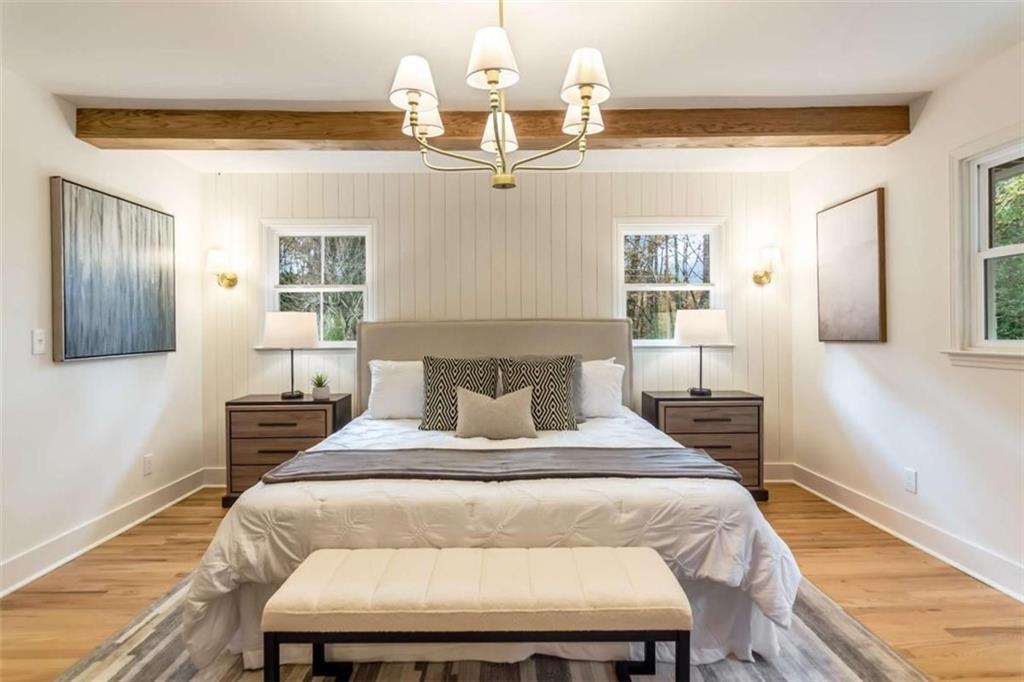4956 Mountclaire Road Stone Mountain, GA 30087 - Photo 29 of 61 a bedroom with a bed and wooden floor