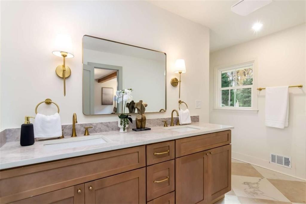 4956 Mountclaire Road Stone Mountain, GA 30087 - Photo 31 of 61 a bathroom with a sink and a mirror