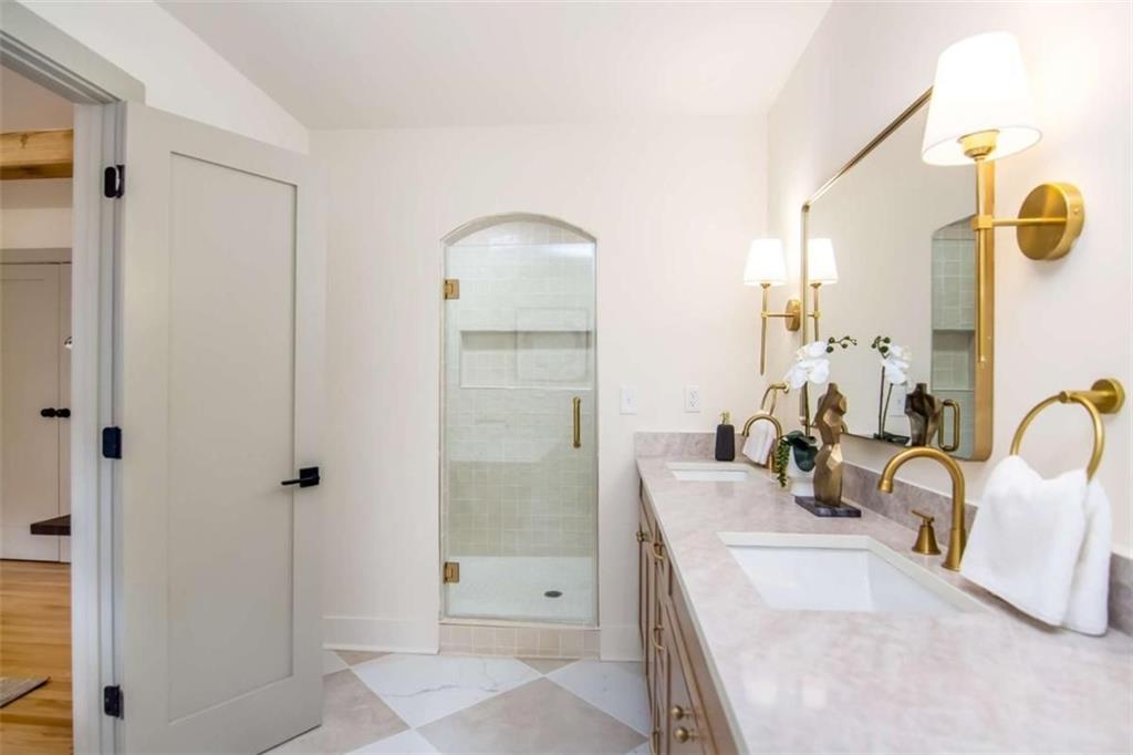 4956 Mountclaire Road Stone Mountain, GA 30087 - Photo 32 of 61 a bathroom with a double vanity sink and mirror