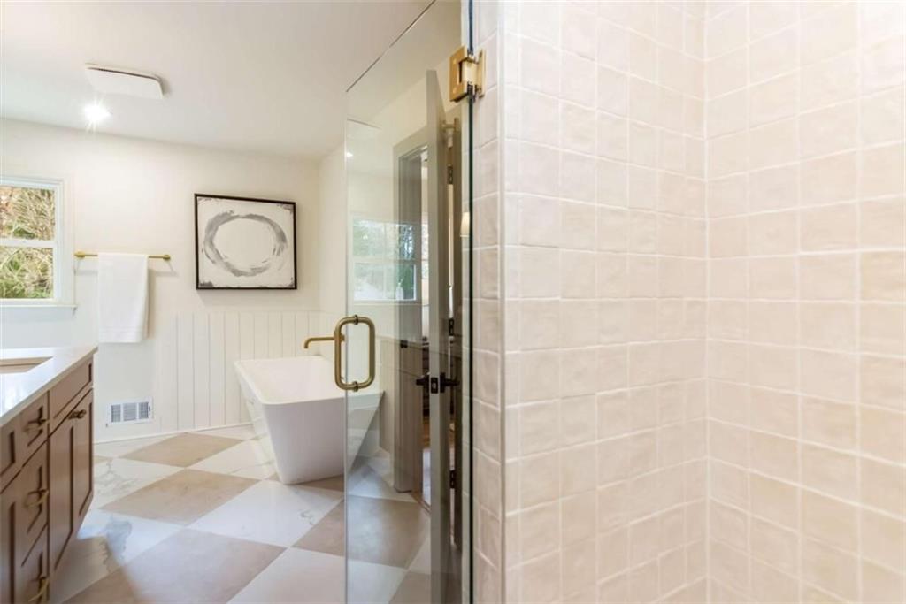 4956 Mountclaire Road Stone Mountain, GA 30087 - Photo 34 of 61 a bathroom with a bathtub and a shower