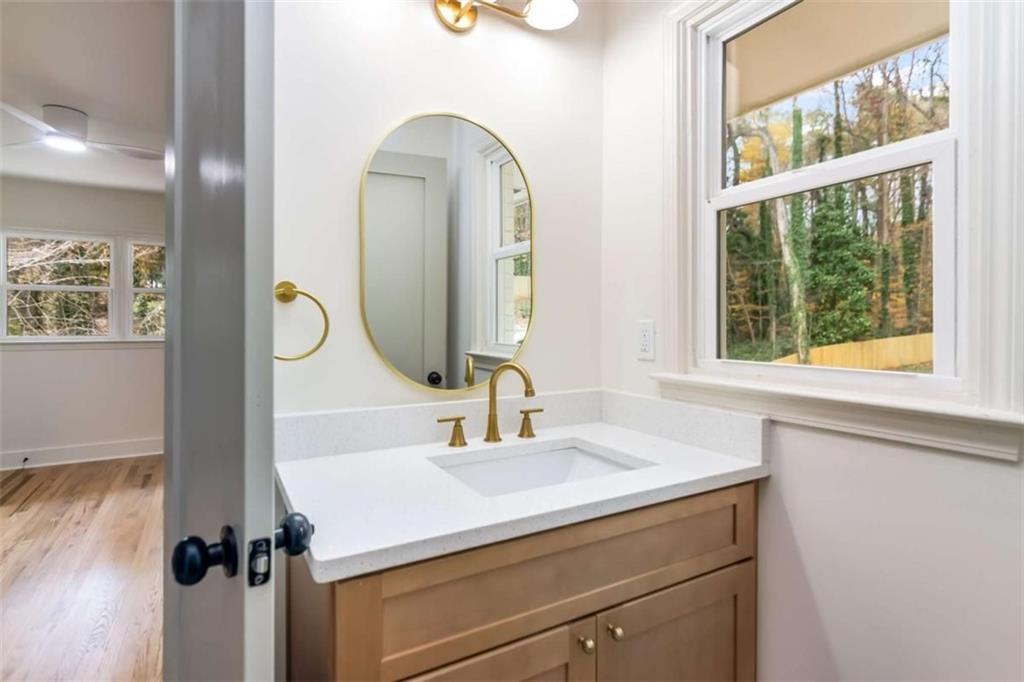 4956 Mountclaire Road Stone Mountain, GA 30087 - Photo 38 of 61 a bathroom with a sink and a mirror