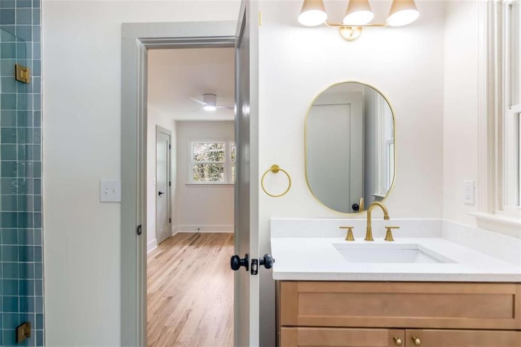 4956 Mountclaire Road Stone Mountain, GA 30087 - Photo 39 of 61 a bathroom with a sink and a mirror