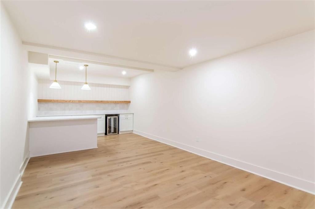 4956 Mountclaire Road Stone Mountain, GA 30087 - Photo 44 of 61 a view of an empty room with wooden floor and a window