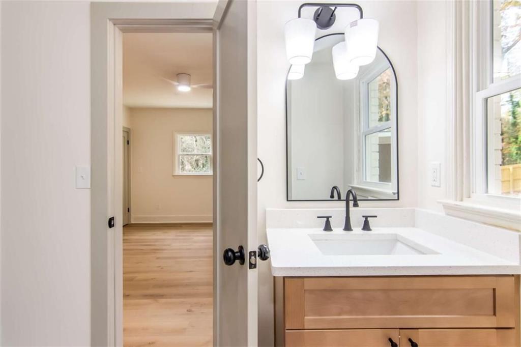 4956 Mountclaire Road Stone Mountain, GA 30087 - Photo 49 of 61 a bathroom with a sink and a mirror