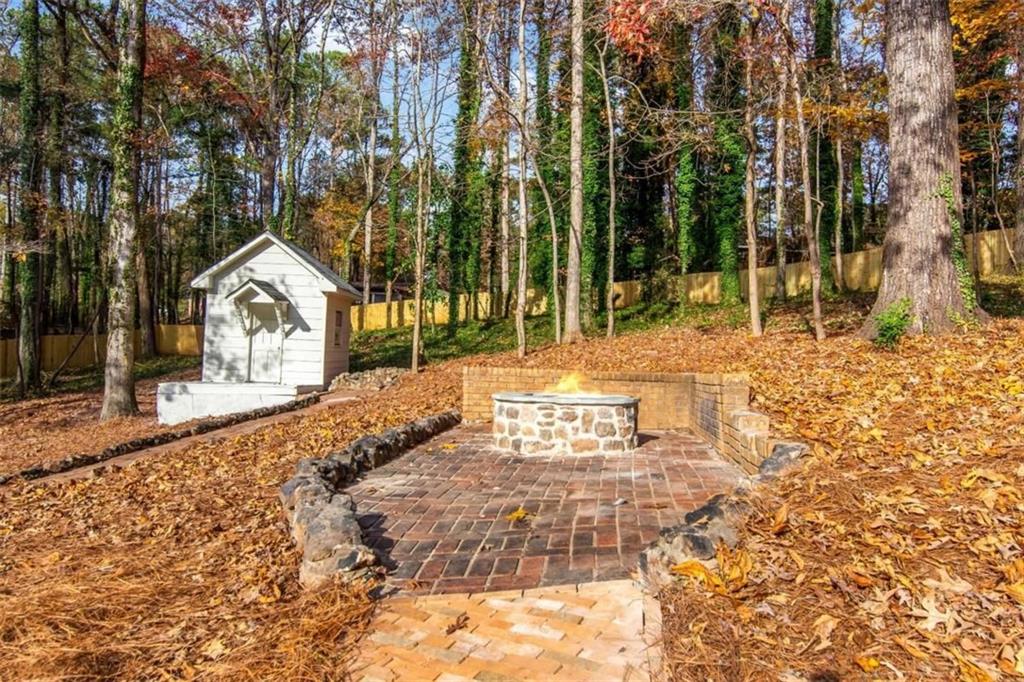 4956 Mountclaire Road Stone Mountain, GA 30087 - Photo 59 of 61 a view of a white house with a yard and sitting area