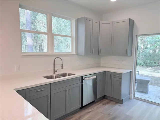 a kitchen with a sink cabinets and window