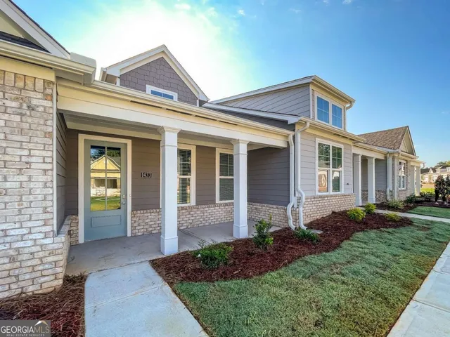 a front view of a house with garden