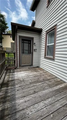 a view of a house with wooden deck