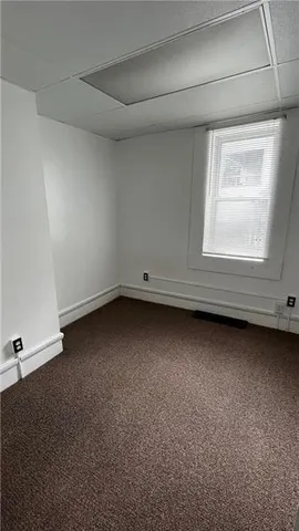 an empty room with a fireplace