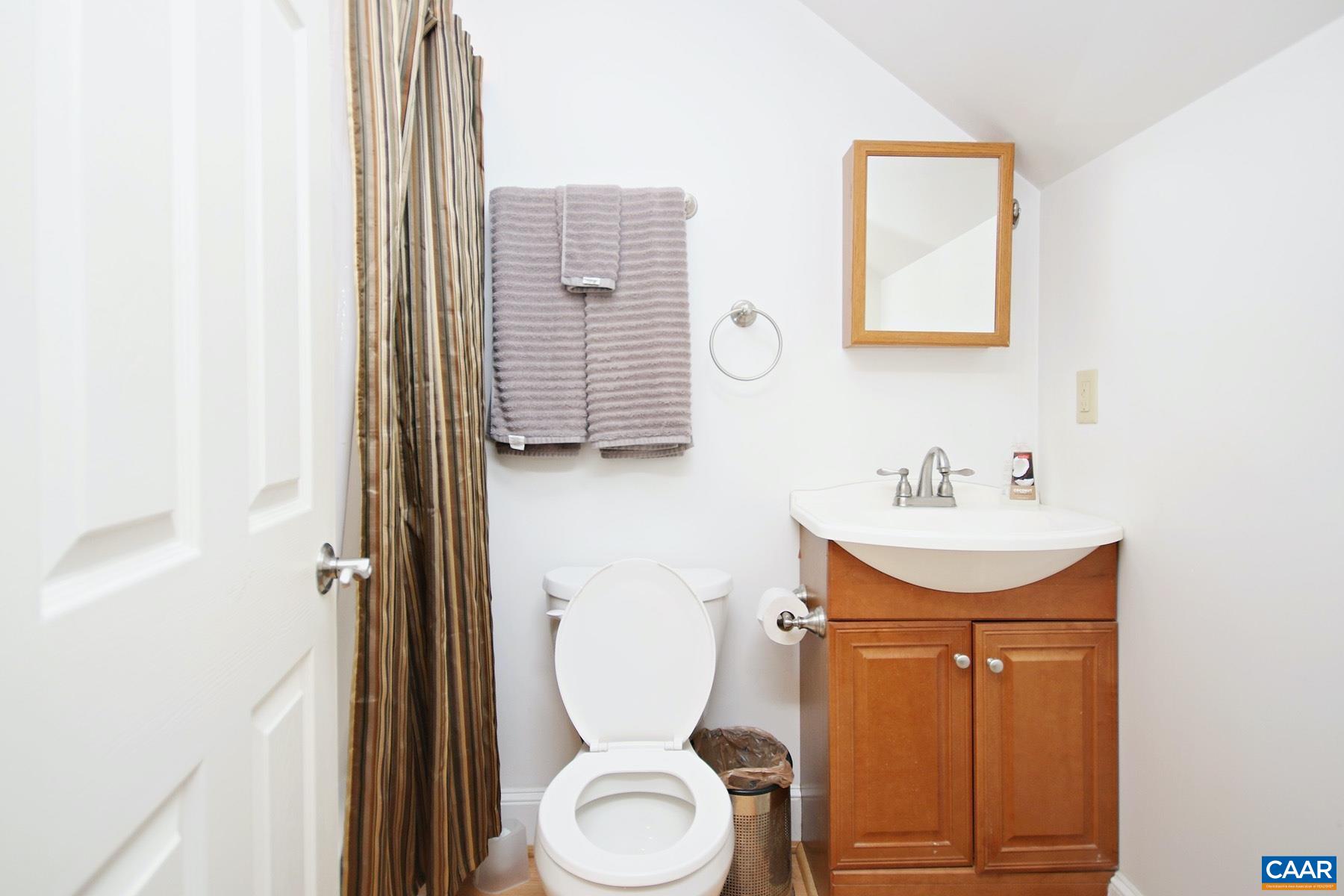 1827 Brandywine Drive, Unit B Charlottesville, VA 22901 - Photo 8 of 10 a bathroom with a toilet sink and mirror