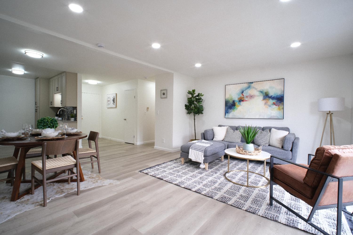 a living room with furniture and wooden floor