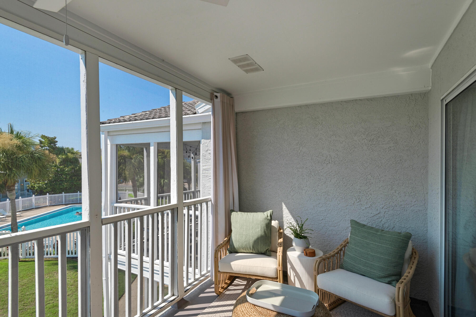 4984 West County Highway 30A, Unit 5B Santa Rosa Beach, FL 32459 - Photo 17 of 46 a balcony with a couch and wooden floor