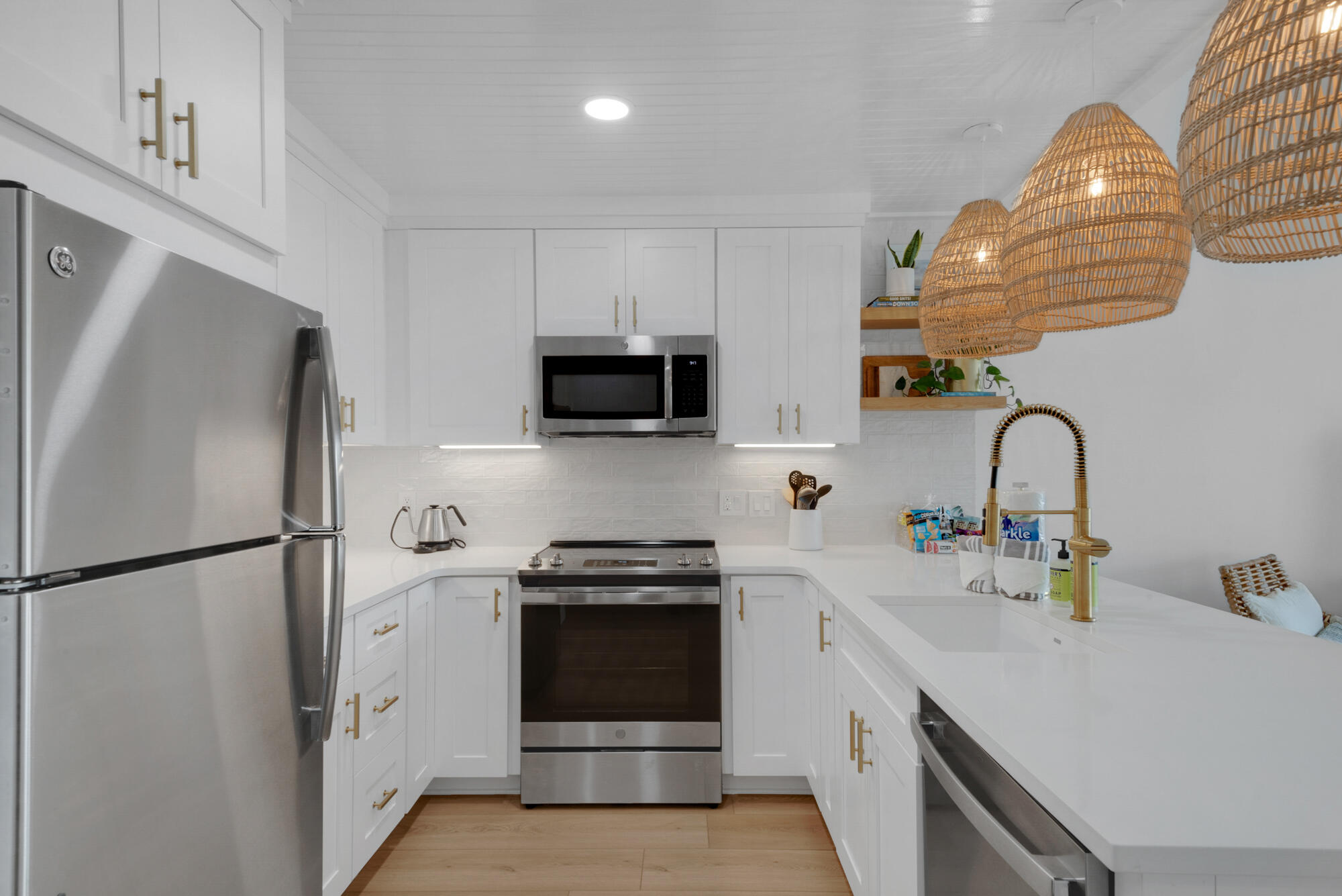 4984 West County Highway 30A, Unit 5B Santa Rosa Beach, FL 32459 - Photo 20 of 46 a kitchen with stainless steel appliances a sink cabinets and a refrigerator