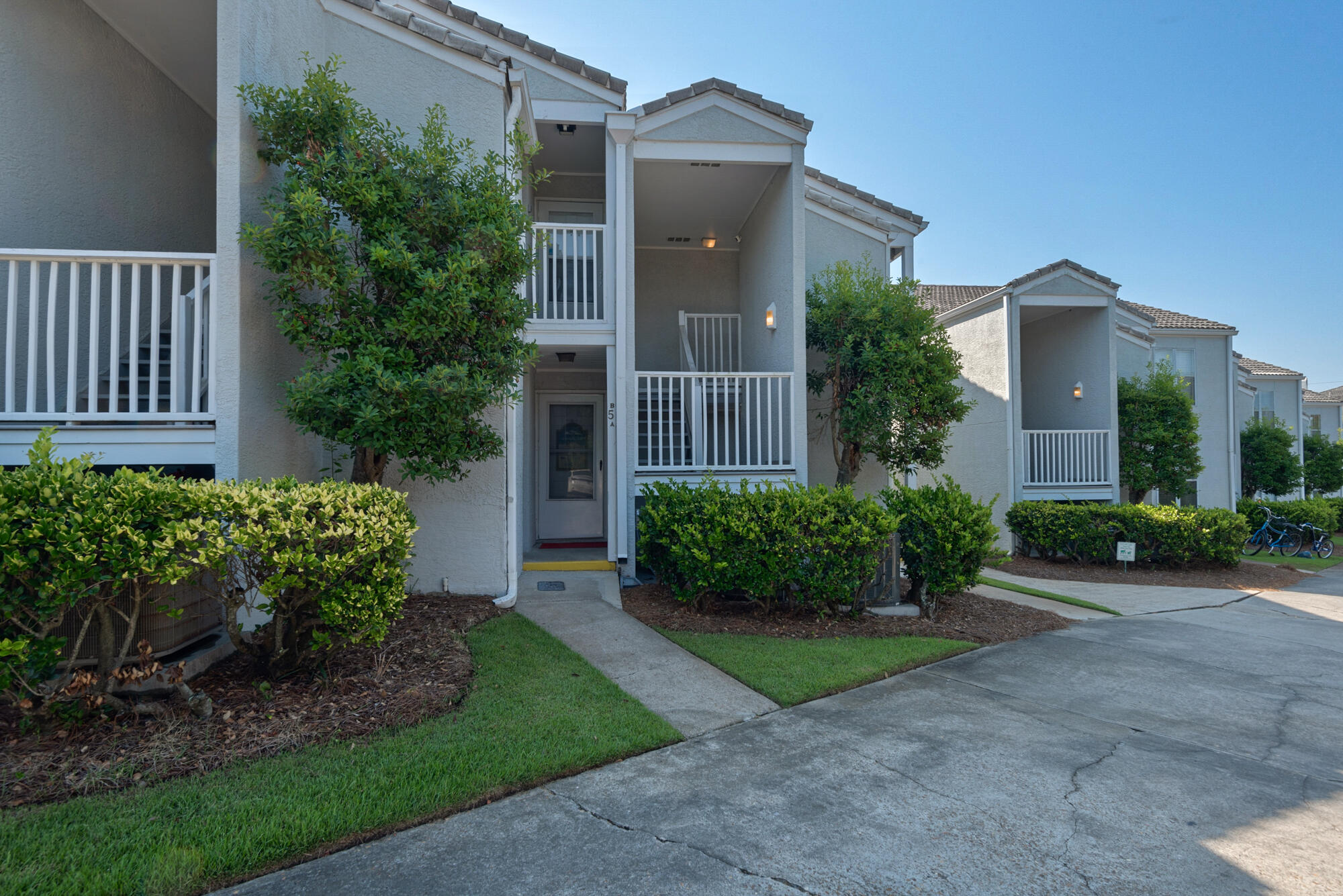 4984 West County Highway 30A, Unit 5B Santa Rosa Beach, FL 32459 - Photo 9 of 46 a view of a house with brick walls plants and large tree