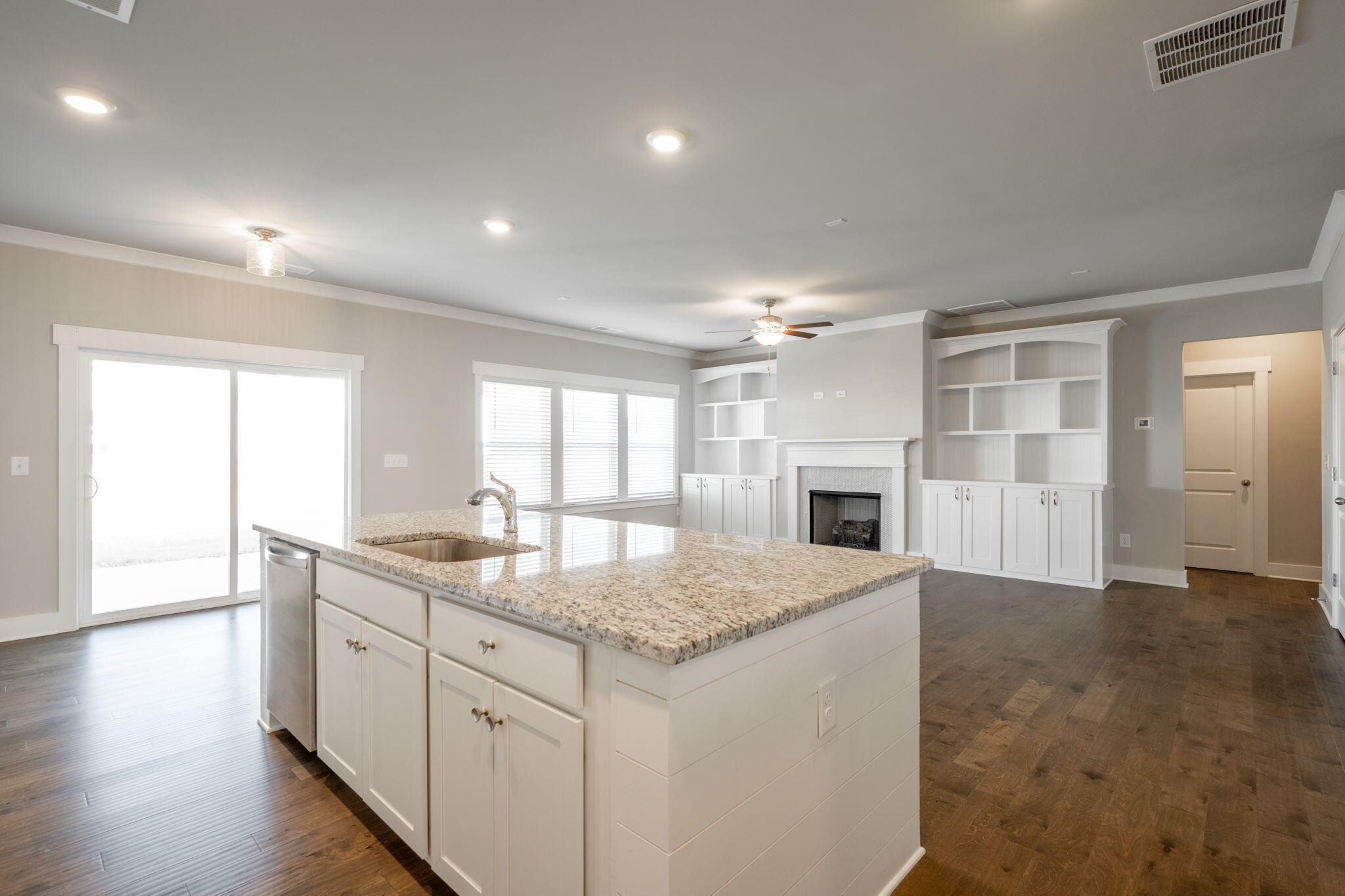 7401 McDaniel Lane Ooltewah, TN 37363 - Photo 11 of 44 a kitchen with a sink chandelier and fireplace