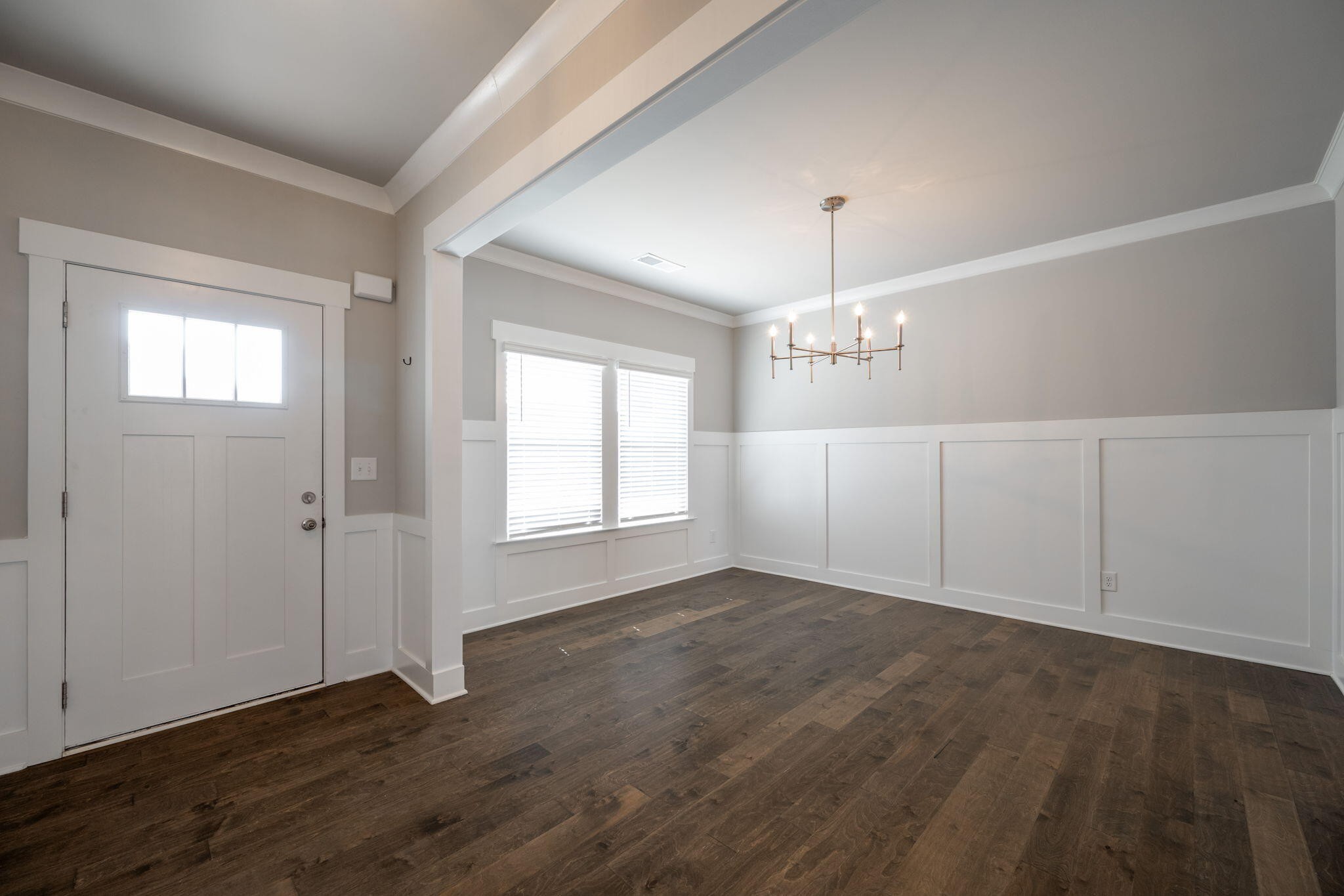 7401 McDaniel Lane Ooltewah, TN 37363 - Photo 13 of 44 an empty room with wooden floor chandelier fan and windows