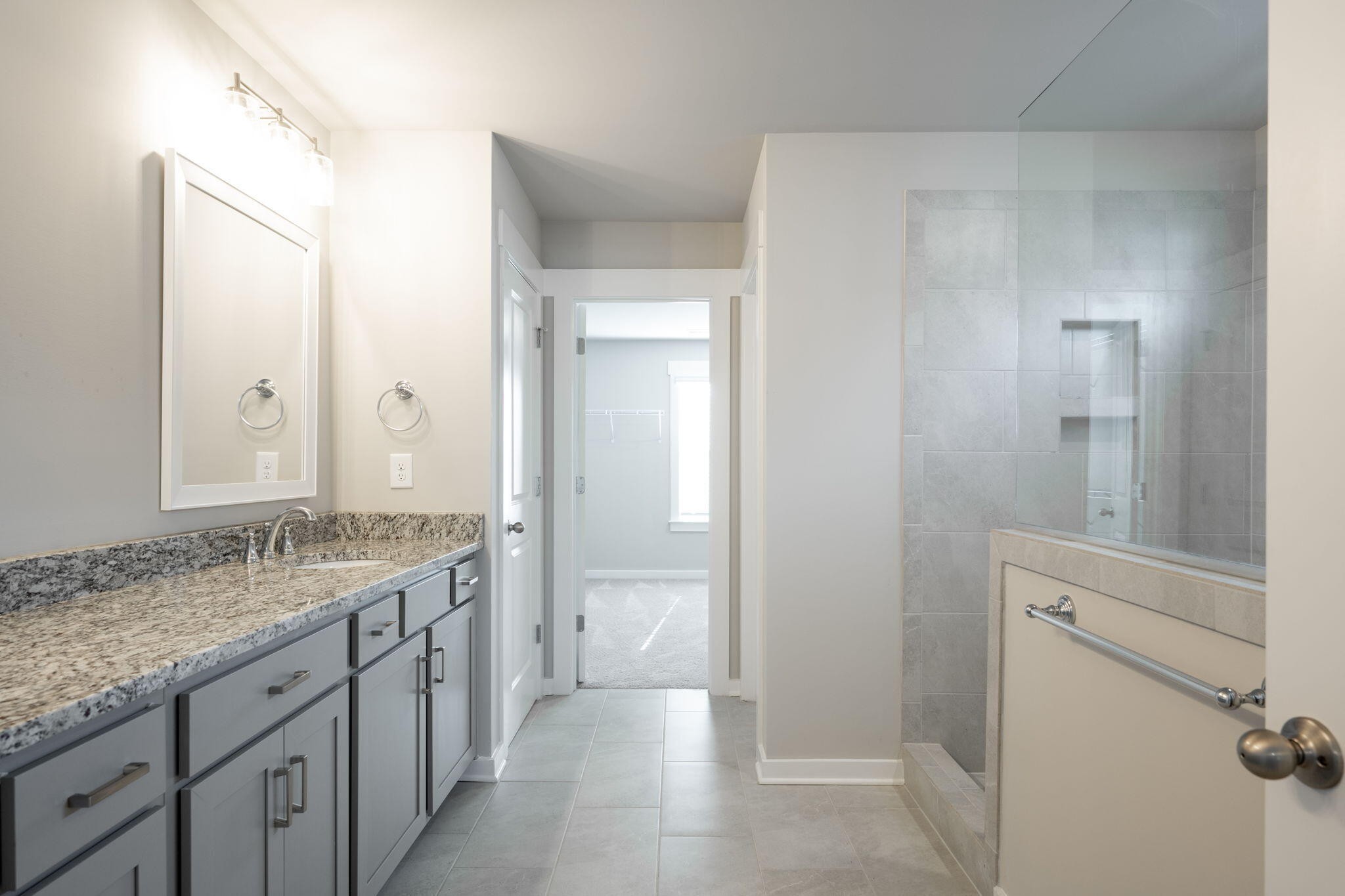 7401 McDaniel Lane Ooltewah, TN 37363 - Photo 19 of 44 a bathroom with a granite countertop sink and a mirror