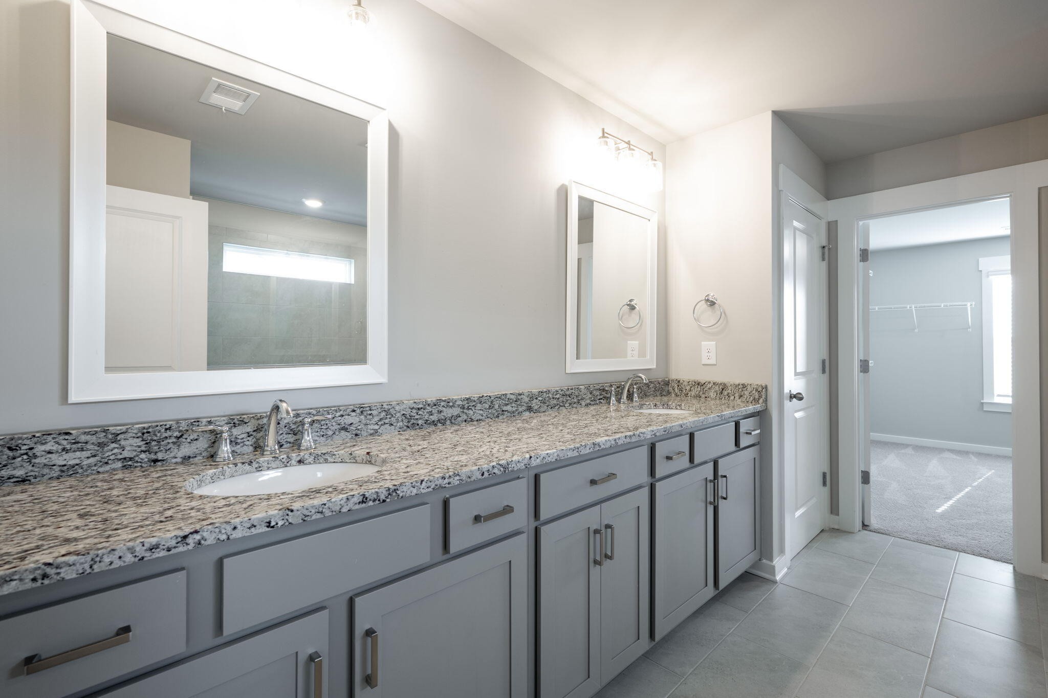 7401 McDaniel Lane Ooltewah, TN 37363 - Photo 20 of 44 a bathroom with a granite countertop sink double and mirror