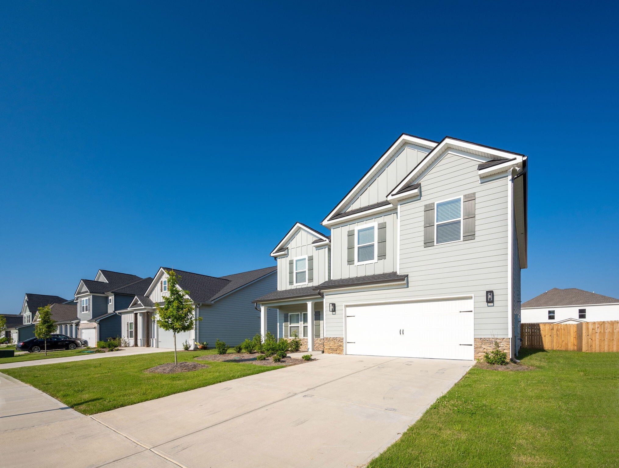 7401 McDaniel Lane Ooltewah, TN 37363 - Photo 3 of 44 a front view of a house with a garden and yard