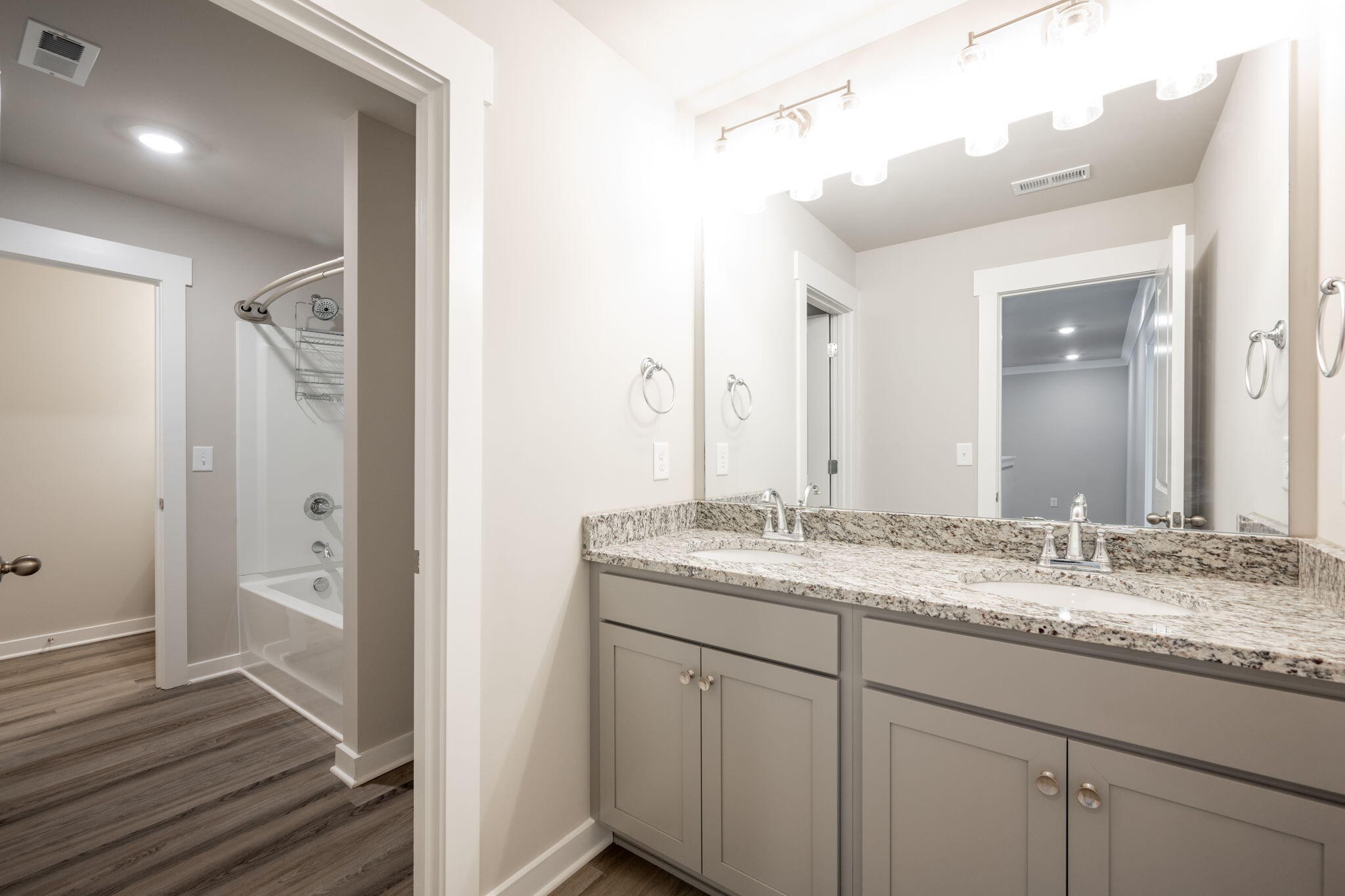7401 McDaniel Lane Ooltewah, TN 37363 - Photo 32 of 44 a bathroom with a granite countertop sink and a mirror