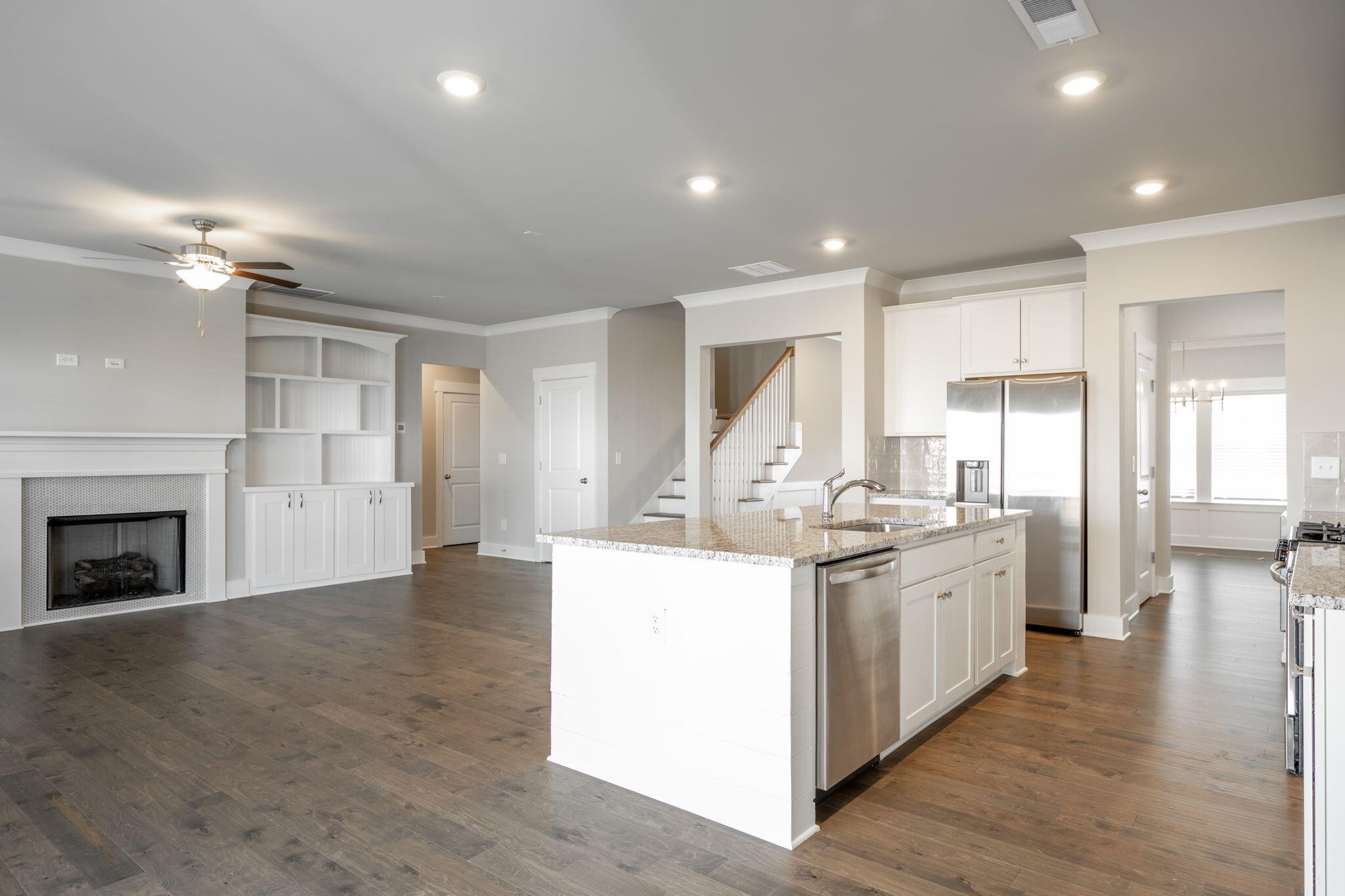 7401 McDaniel Lane Ooltewah, TN 37363 - Photo 9 of 44 a kitchen with stainless steel appliances kitchen island granite countertop a stove and a sink