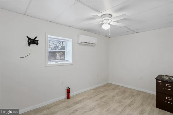 an empty room with a fan and a fan