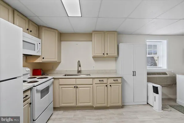 a kitchen with stainless steel appliances a sink stove and cabinets