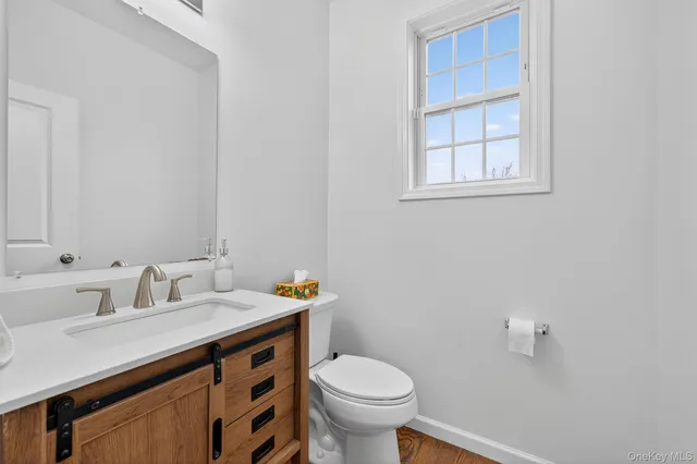 a bathroom with a sink toilet and a mirror