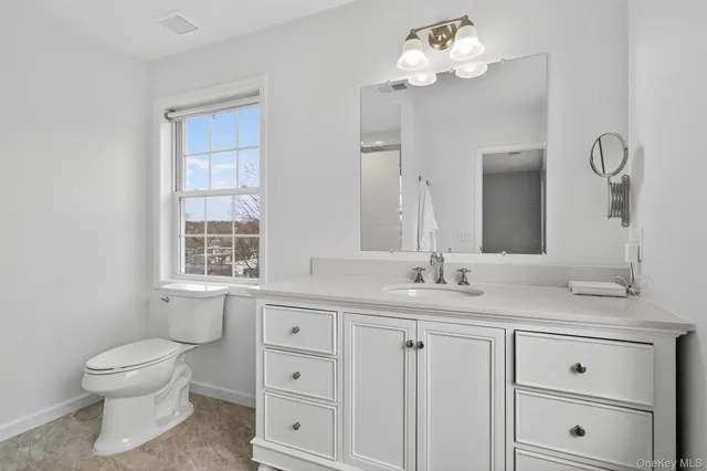 a bathroom with a sink vanity and a mirror