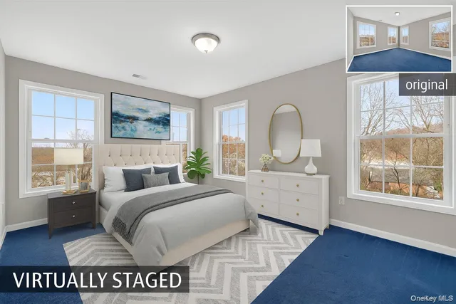 a spacious bedroom with a bed a dresser next to a window