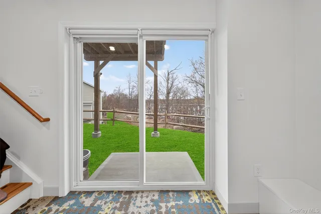 a view of a porch with a floor to ceiling window