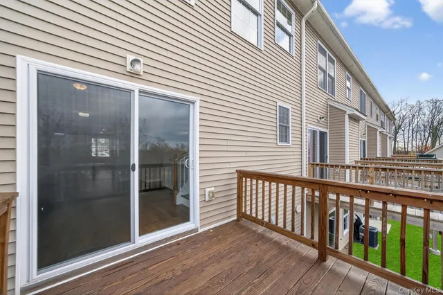 a view of a balcony with wooden floor and fence