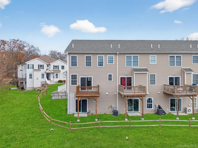 a front view of building with play ground and trees
