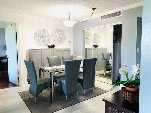 a view of a dining room with furniture and a potted plant
