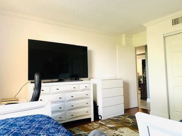a bedroom with a bed and flat screen tv