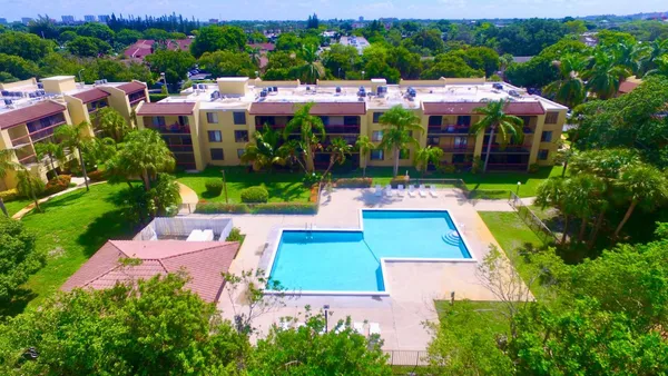 a view of yard with swimming pool and green space
