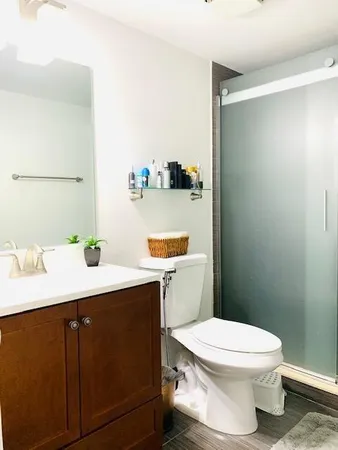 a bathroom with a sink mirror vanity and toilet