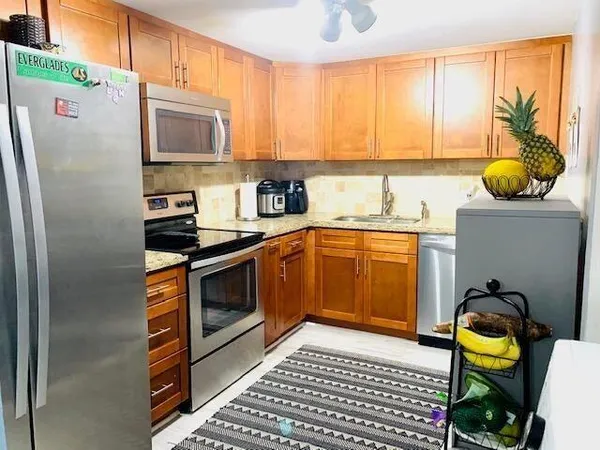 a kitchen with a sink appliances and cabinets