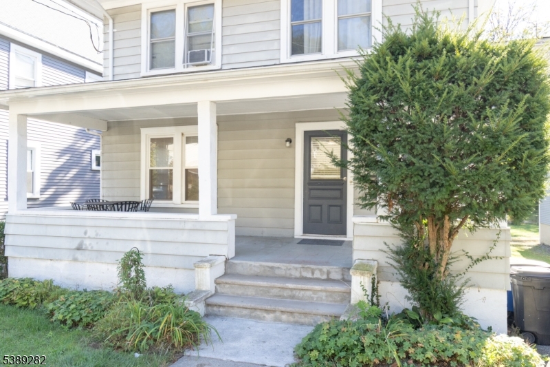 a view of a house with potted plants